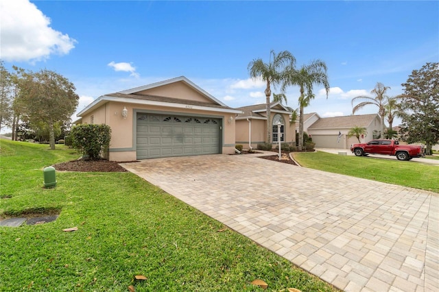 ranch-style home with a garage and a front lawn