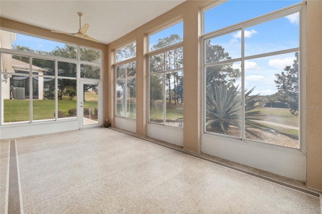 unfurnished sunroom with ceiling fan