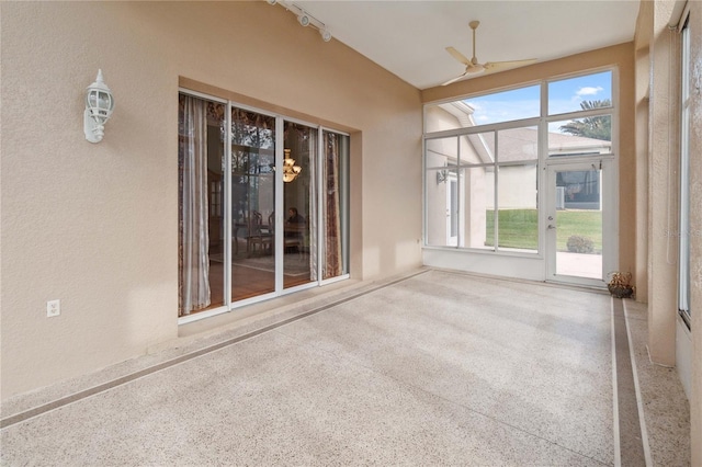 unfurnished sunroom featuring ceiling fan