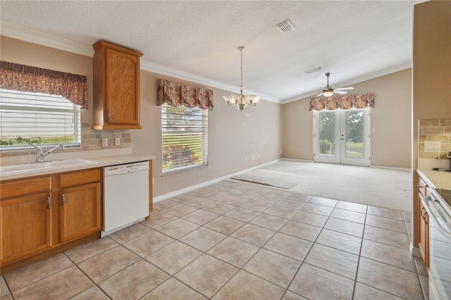 kitchen featuring pendant lighting, backsplash, light tile patterned floors, and dishwasher