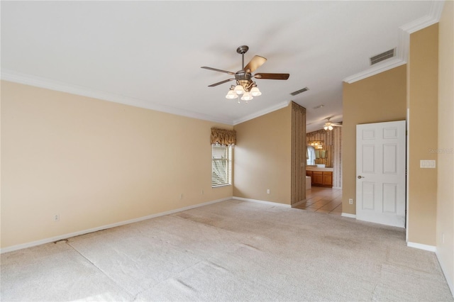 carpeted spare room with ceiling fan and ornamental molding