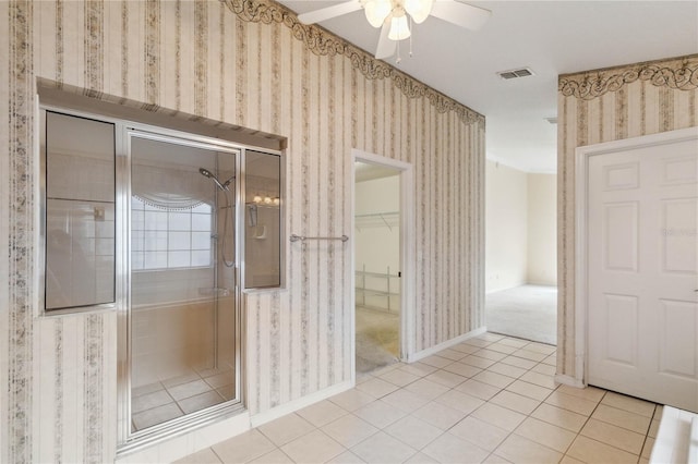 bathroom featuring ceiling fan and tile patterned flooring