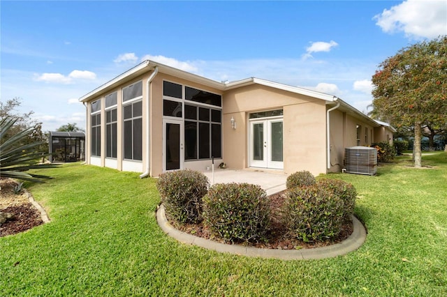 back of house featuring a patio area, cooling unit, a yard, and a sunroom