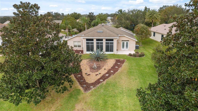 rear view of house featuring a lawn