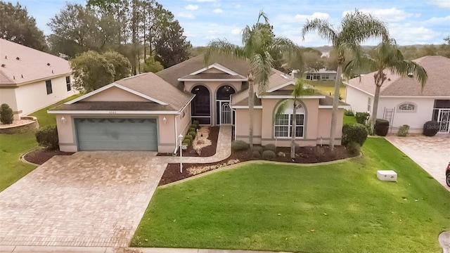 view of front of house featuring a garage and a front lawn