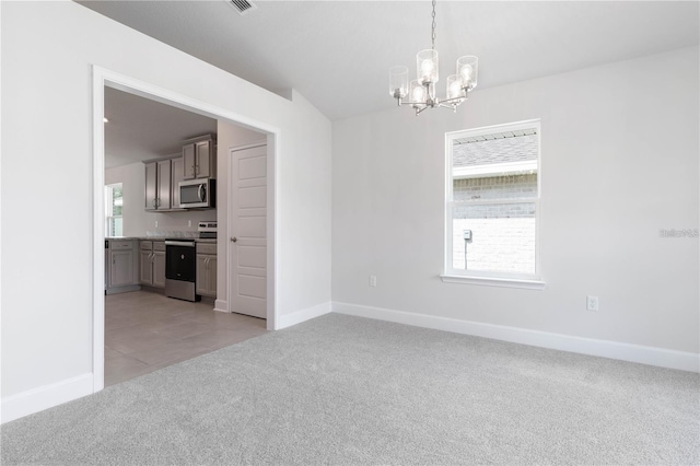 empty room with light carpet and an inviting chandelier