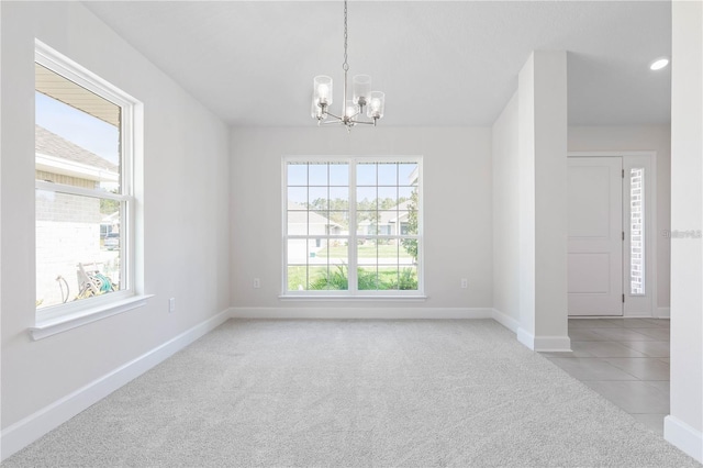 unfurnished room with light carpet and a chandelier