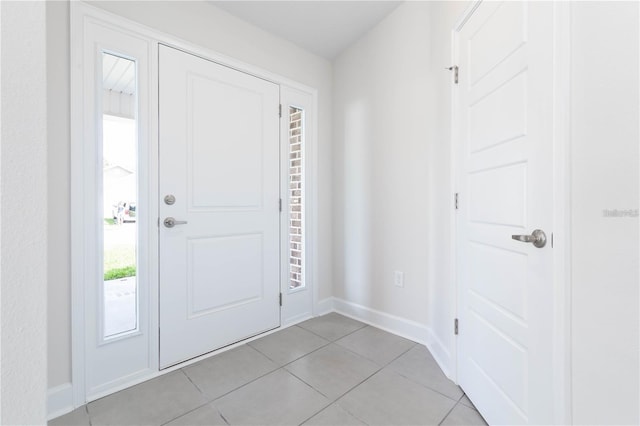 foyer entrance with light tile patterned flooring