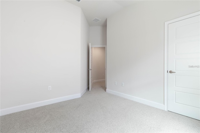 unfurnished bedroom with vaulted ceiling and carpet floors