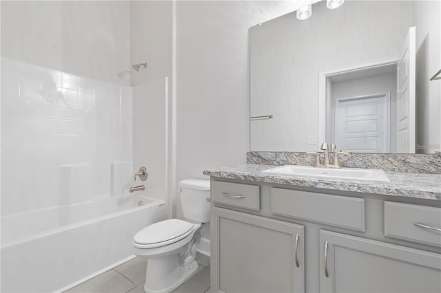 full bathroom with tub / shower combination, tile patterned floors, toilet, and vanity