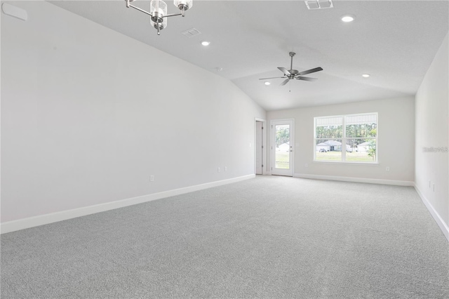 unfurnished room with ceiling fan with notable chandelier, light colored carpet, and lofted ceiling