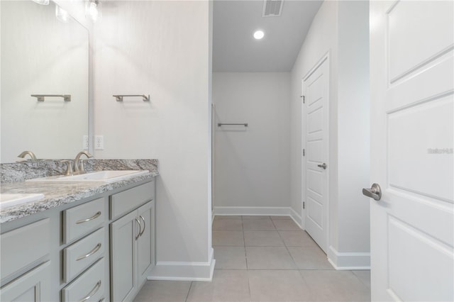 bathroom with tile patterned flooring and vanity