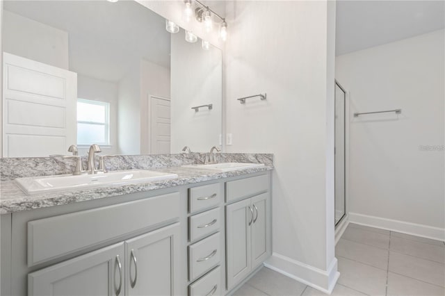 bathroom with vanity, a shower with shower door, and tile patterned flooring