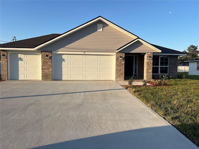 ranch-style home with driveway, a garage, and brick siding