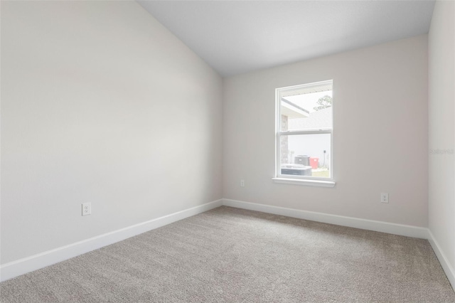 48 Bannbury Ln, Palm Coast, FL 32137 - carpeted spare room featuring baseboards and vaulted ceiling