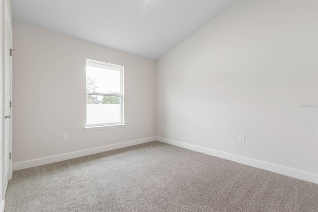 48 Bannbury Ln, Palm Coast, FL 32137 - unfurnished room featuring baseboards, carpet flooring, and vaulted ceiling
