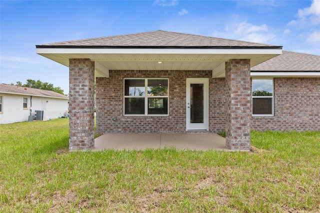 48 Bannbury Ln, Palm Coast, FL 32137 - back of house featuring a patio, a lawn, a shingled roof, and brick siding