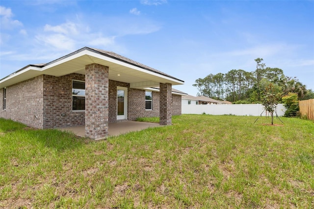 48 Bannbury Ln, Palm Coast, FL 32137 - back of house with brick siding and a patio