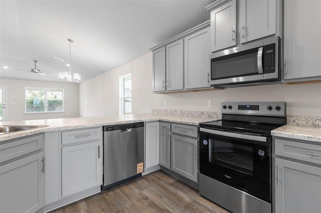 48 Bannbury Ln, Palm Coast, FL 32137 - kitchen featuring stainless steel appliances, gray cabinets, dark wood finished floors, a chandelier, and a sink