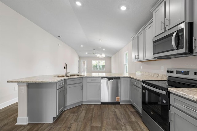 48 Bannbury Ln, Palm Coast, FL 32137 - kitchen with stainless steel appliances, a sink, gray cabinets, dark wood-style flooring, and lofted ceiling