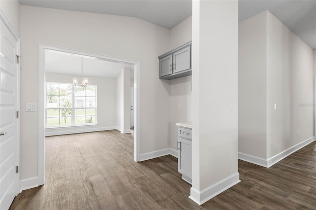 48 Bannbury Ln, Palm Coast, FL 32137 - hall with a chandelier, dark wood-type flooring, lofted ceiling, and baseboards