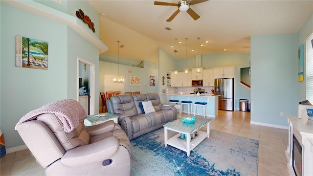 living room with ceiling fan with notable chandelier, light tile patterned floors, and high vaulted ceiling