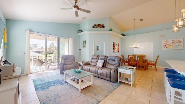 living room with light tile patterned flooring, ceiling fan with notable chandelier, and high vaulted ceiling