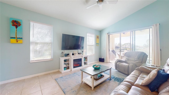 living room featuring plenty of natural light, lofted ceiling, and light tile patterned floors