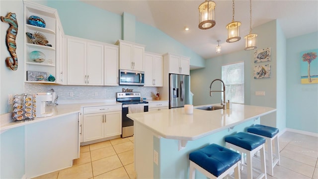 kitchen with tasteful backsplash, white cabinetry, appliances with stainless steel finishes, and sink