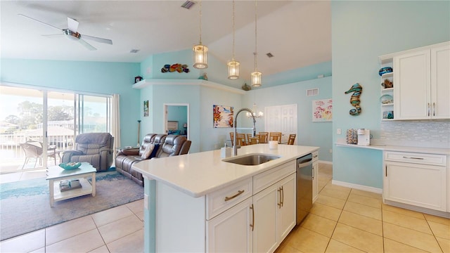 kitchen with white cabinetry, sink, stainless steel dishwasher, and hanging light fixtures