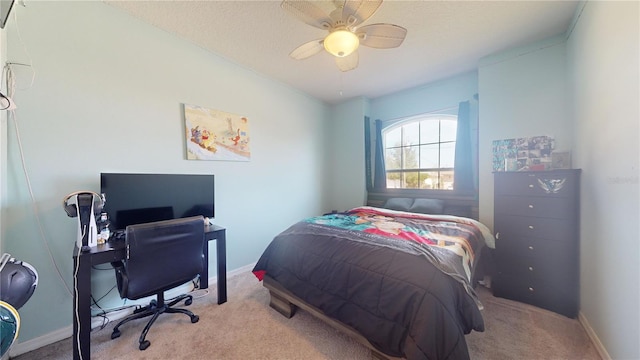 bedroom featuring light carpet, a textured ceiling, and ceiling fan