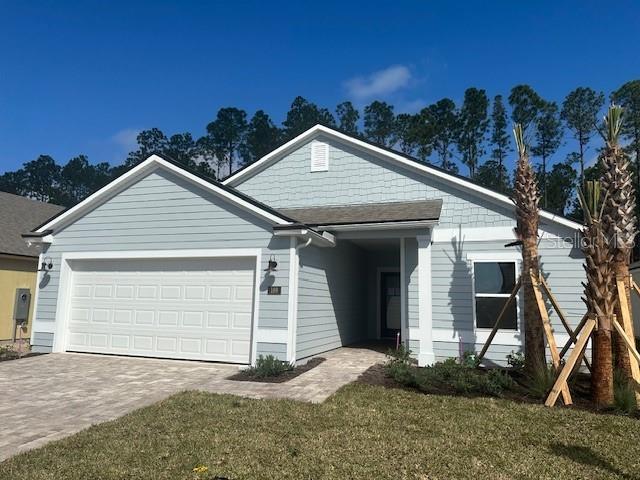 view of front of home featuring a garage and a front lawn