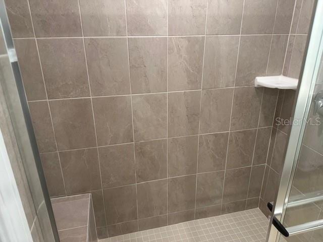 bathroom with a tile shower