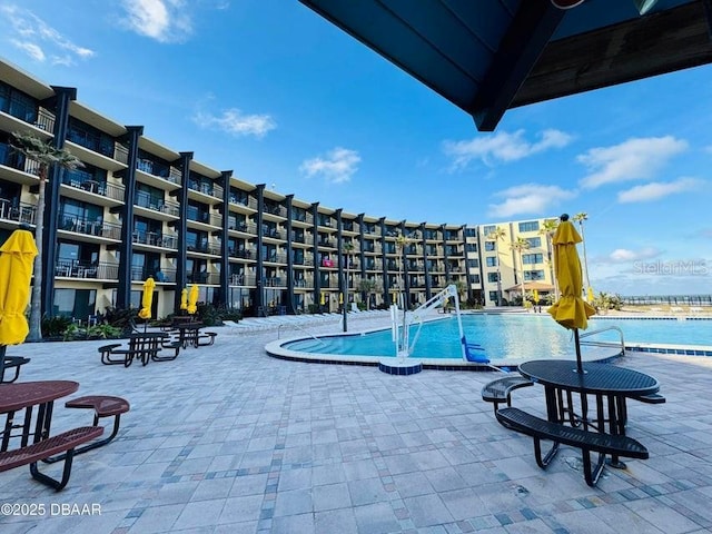 view of swimming pool with a water view