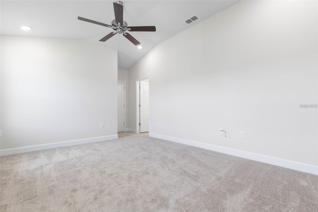 carpeted spare room with vaulted ceiling and ceiling fan