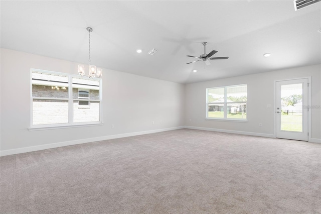 unfurnished room featuring ceiling fan with notable chandelier, carpet flooring, and vaulted ceiling