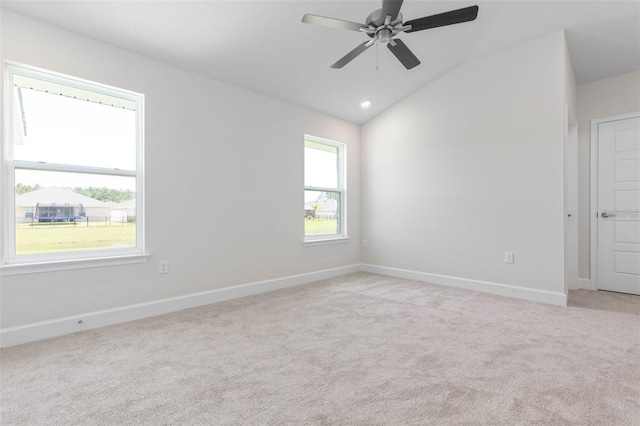 carpeted empty room with ceiling fan and lofted ceiling