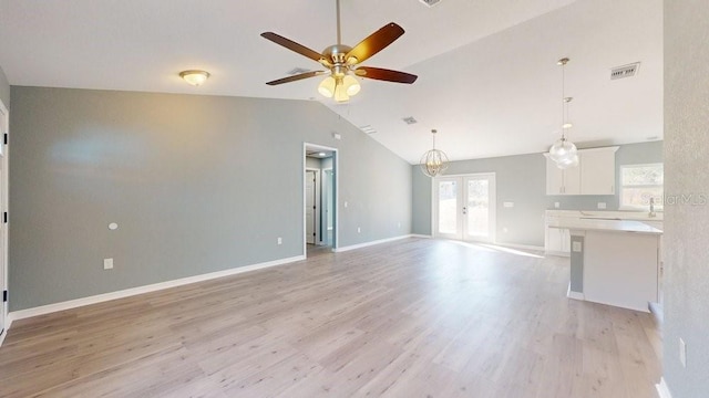 unfurnished living room featuring french doors, ceiling fan, lofted ceiling, and light wood-type flooring