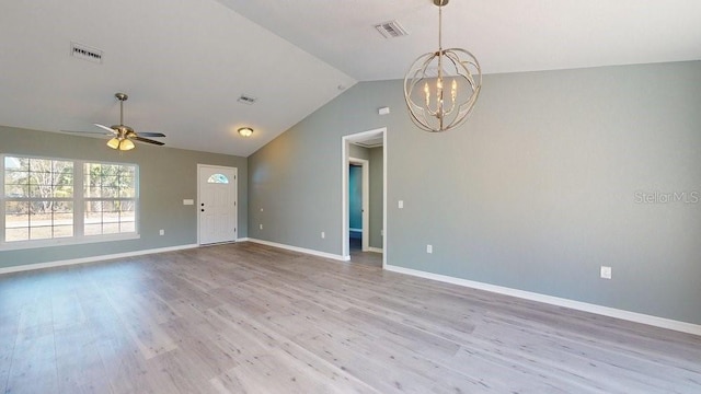 interior space with vaulted ceiling, ceiling fan with notable chandelier, and light wood-type flooring