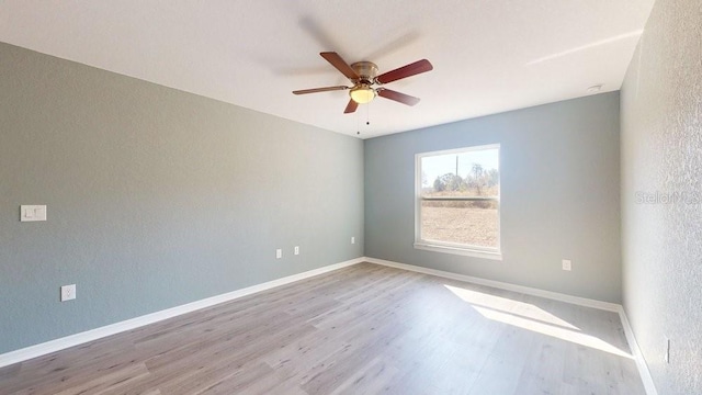 empty room with light hardwood / wood-style floors and ceiling fan