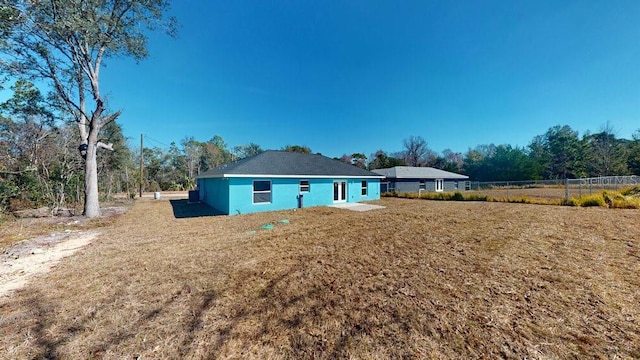 back of house with a yard