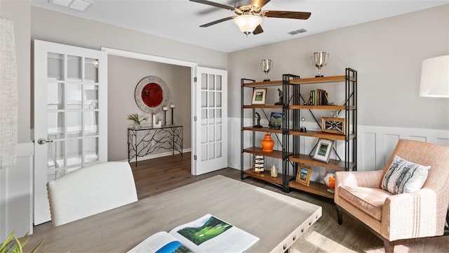 living area with dark hardwood / wood-style flooring, ceiling fan, and french doors