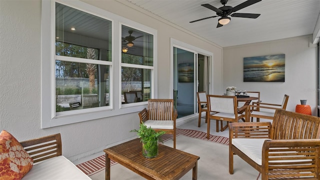 sunroom featuring ceiling fan