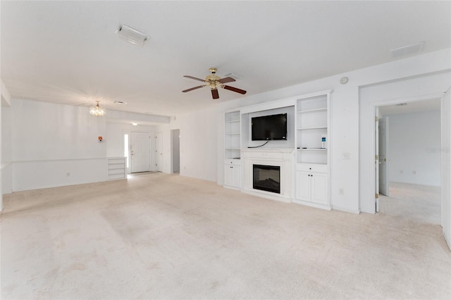 unfurnished living room featuring ceiling fan and light colored carpet