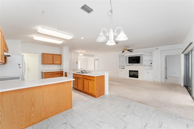 kitchen featuring sink, kitchen peninsula, pendant lighting, white appliances, and ceiling fan with notable chandelier