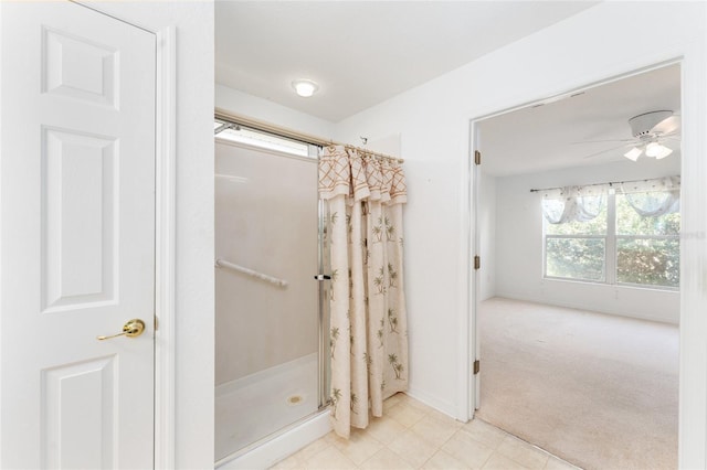 bathroom featuring ceiling fan and a shower