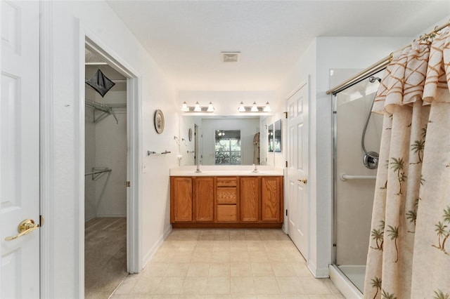 bathroom featuring vanity and a shower with door