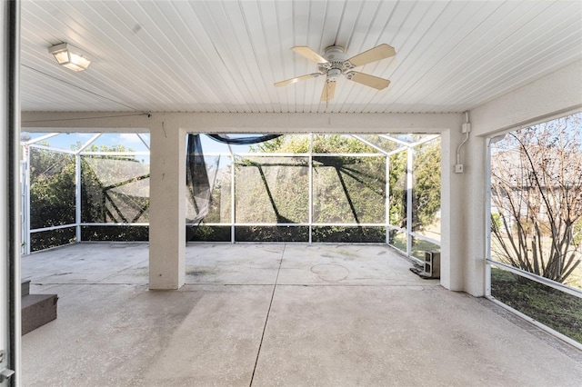 unfurnished sunroom featuring ceiling fan