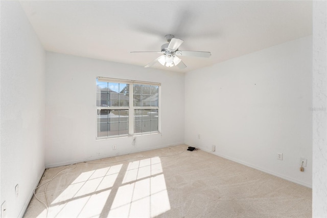 empty room with light colored carpet and ceiling fan