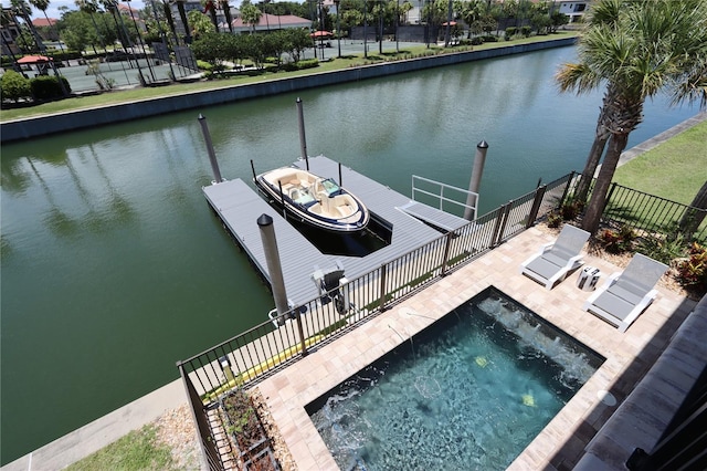 view of dock with a hot tub and a water view